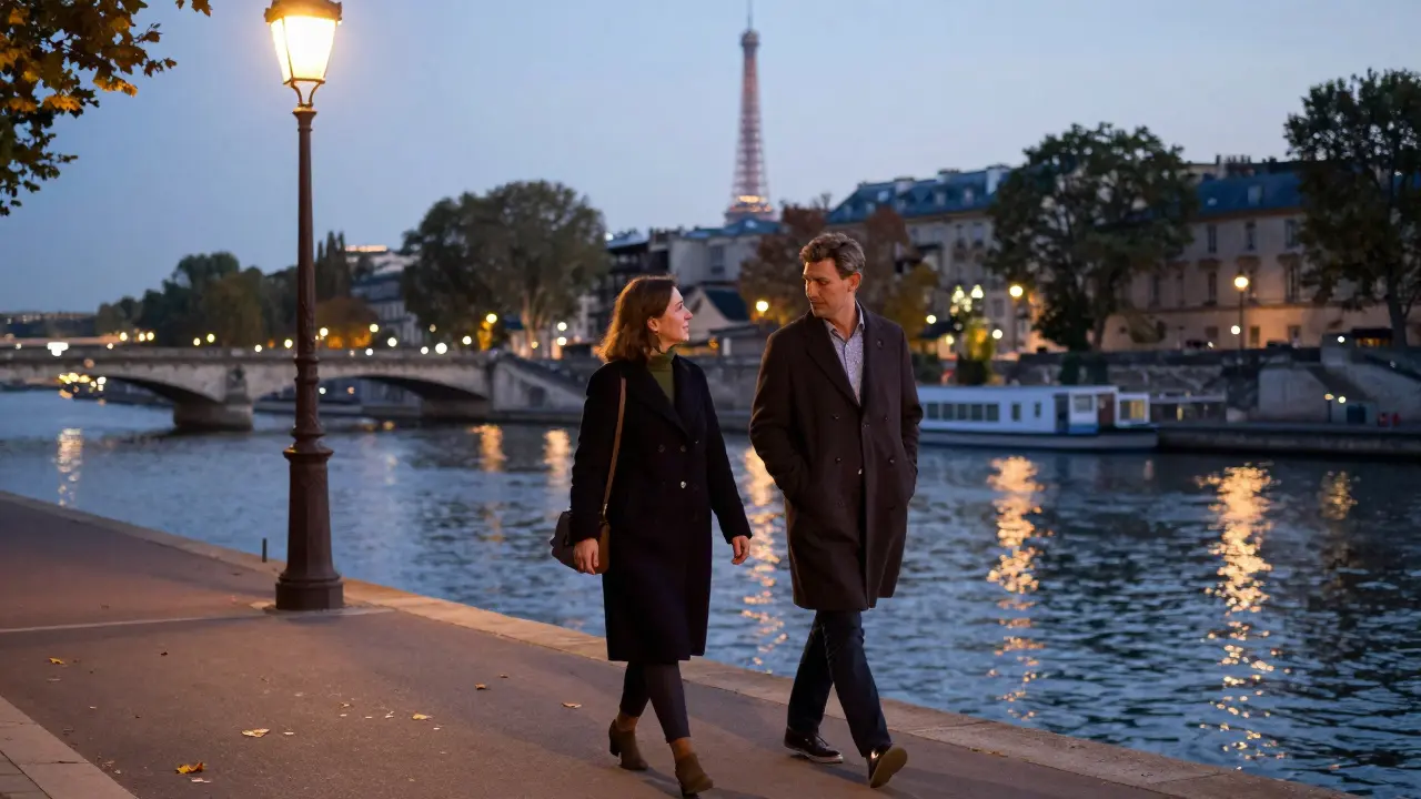 A man and woman walking peacefully along the Seine at dusk, conversing quietly.