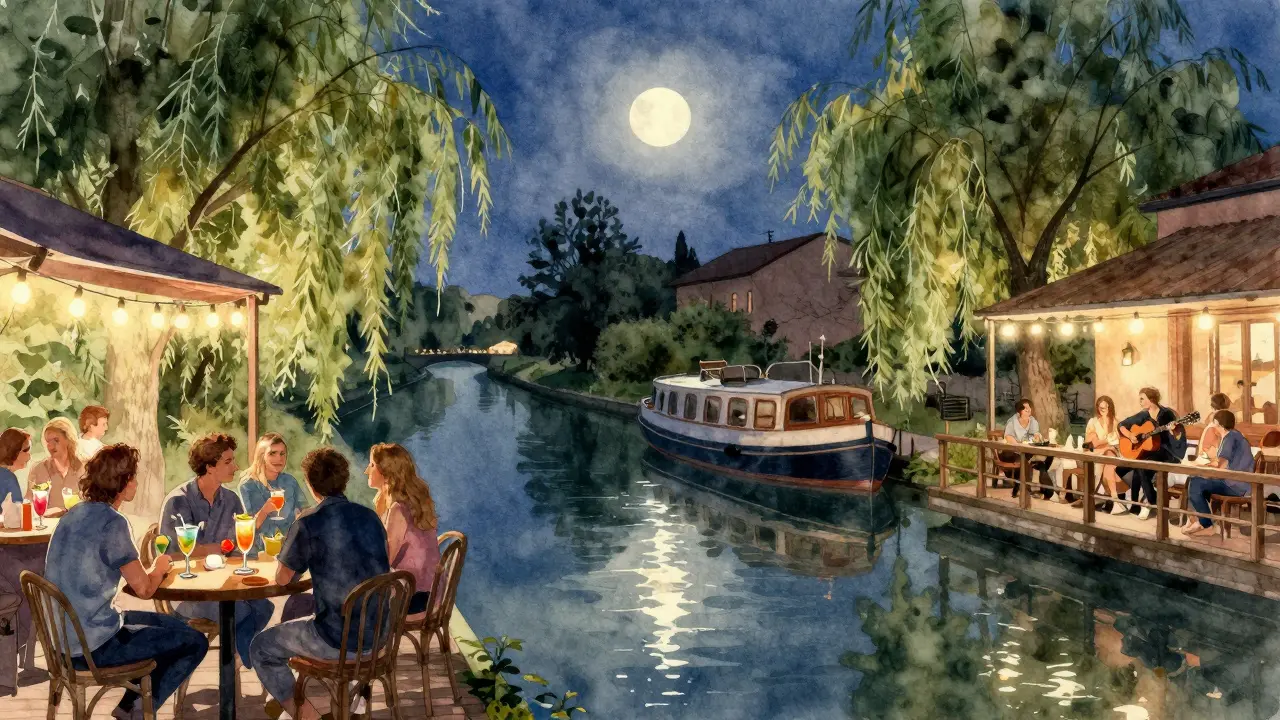 Canal-side bars at Naviglio Grande under string lights, people drinking and listening to live music at night.